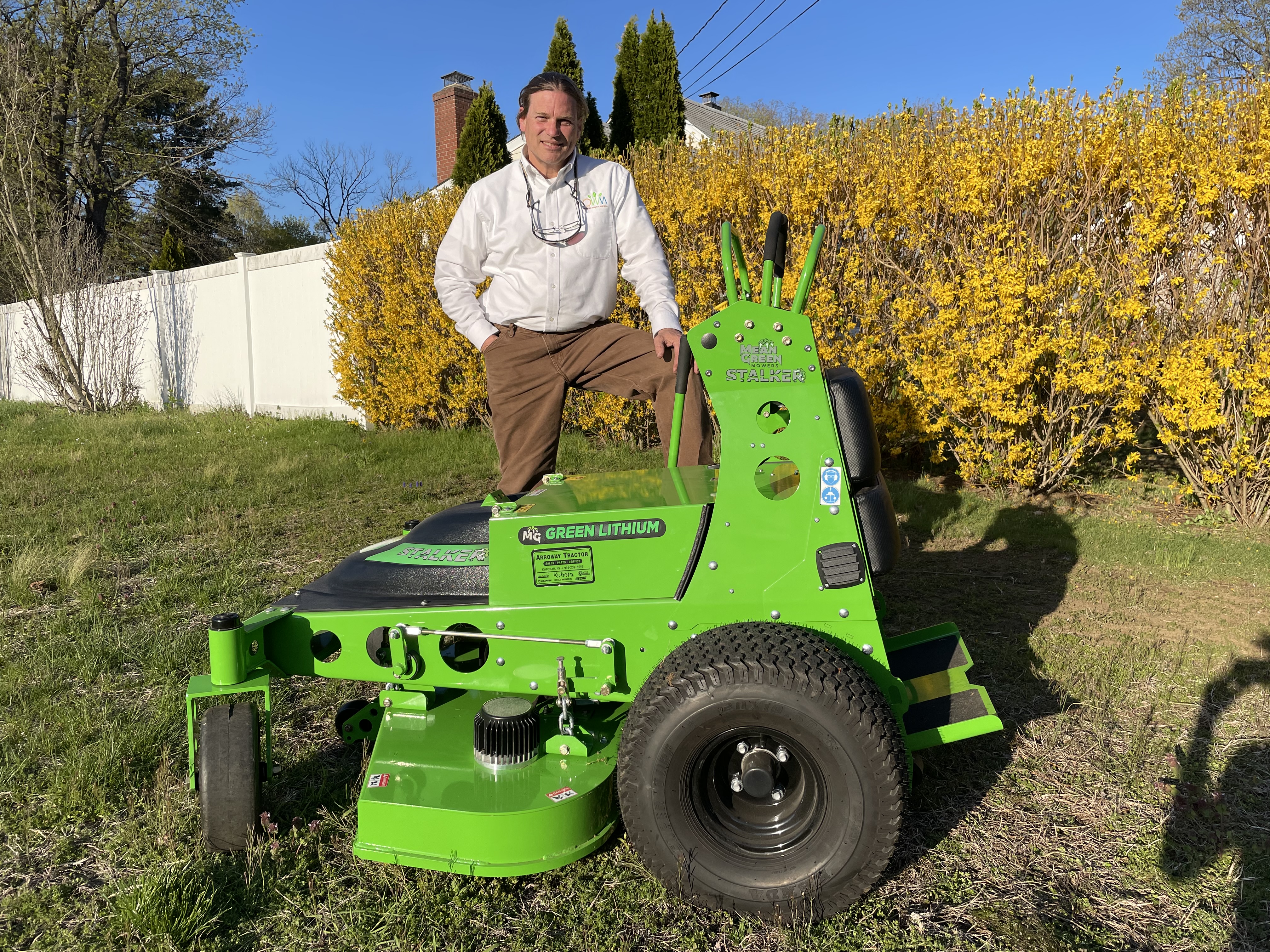 Jeff Cordulack, founder of Organic Ways & Means, with his electric Mean Green Stalker mower